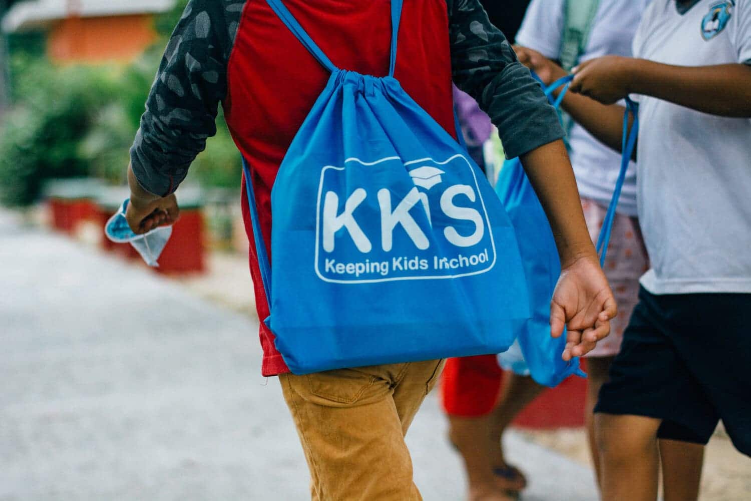 KKIS Project - Kid walking with KKIS backpack